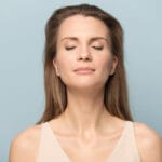 Woman in her forties breathing fresh air thanks to her energy recovery ventilator (ERV)