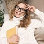 A woman wearing a white sweater inside her warm home in Charlottesville Virginia