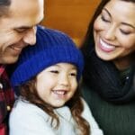 Happy family with mother, father and daughter in Charlottesville home made safe for winter.