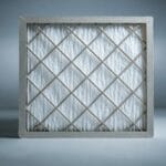 HVAC technician in Albemarle County replacing a dusty air filter to improve indoor air quality.